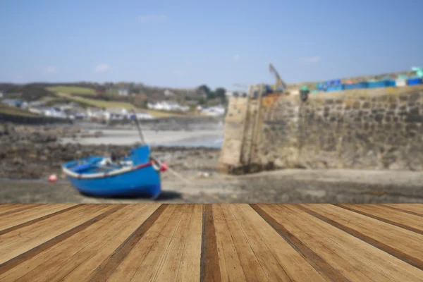 Harbour at low tide with fishing boats in old Cornish fishing vi