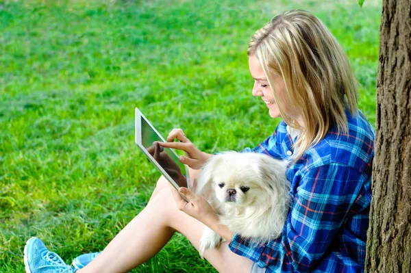 Girl using a digital tablet outdoors