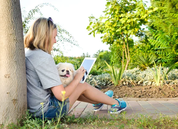 Girl using a digital tablet outdoors