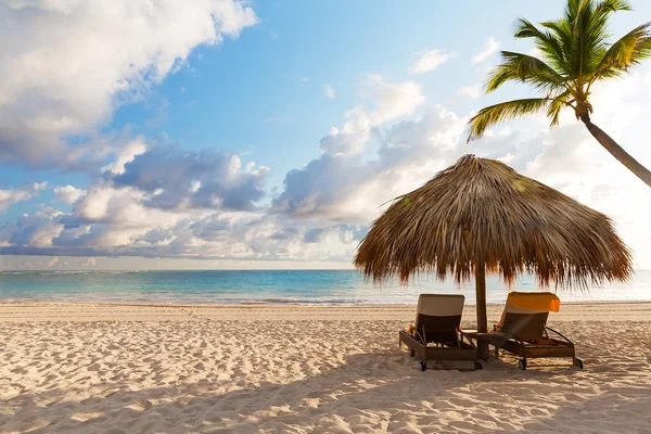 Beach chairs with umbrella and beautiful sand beach