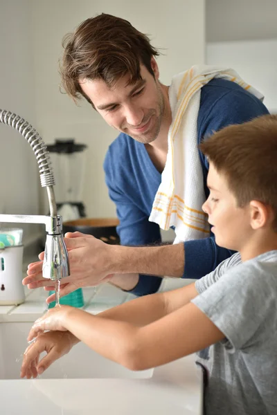 Father and son washing hands