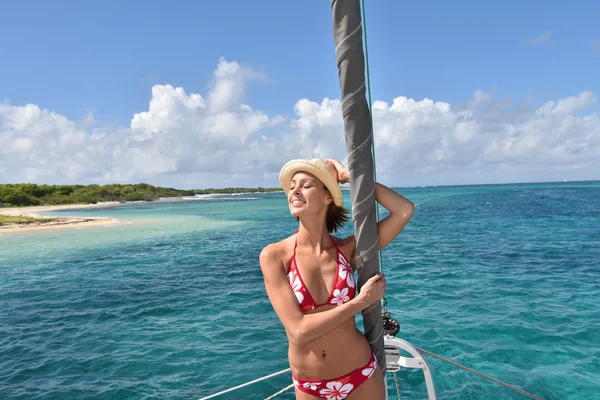 Woman standing by catamaran mast