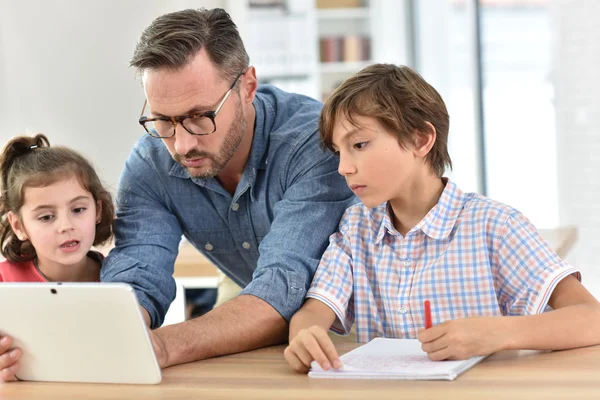 Teacher with students  using digital tablet