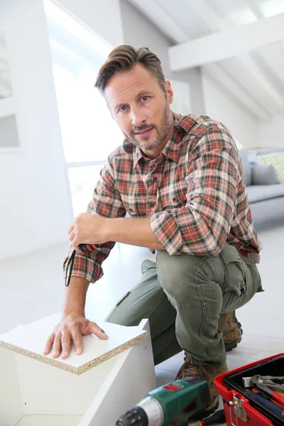 Man  assembling furniture parts