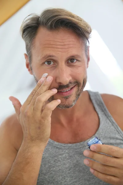 Man applying anti-wrinkle cream