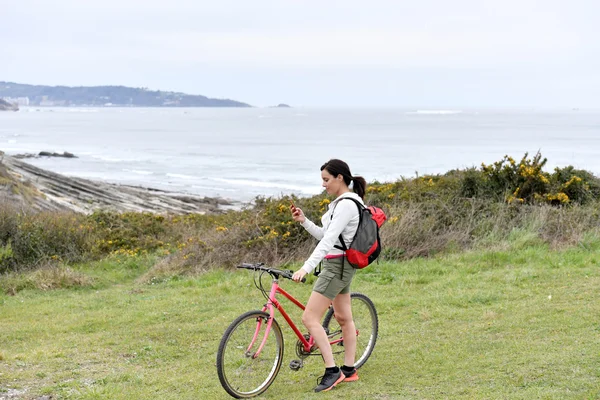 Woman on biking journey reading message