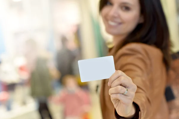 Woman holding card in shopping mall