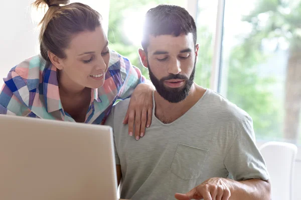 Couple looking at  website on laptop