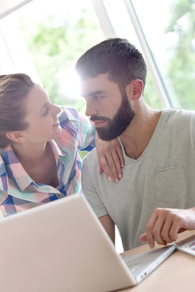Couple looking at  website on laptop