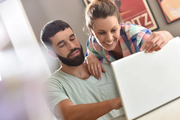 Couple looking at  website on laptop