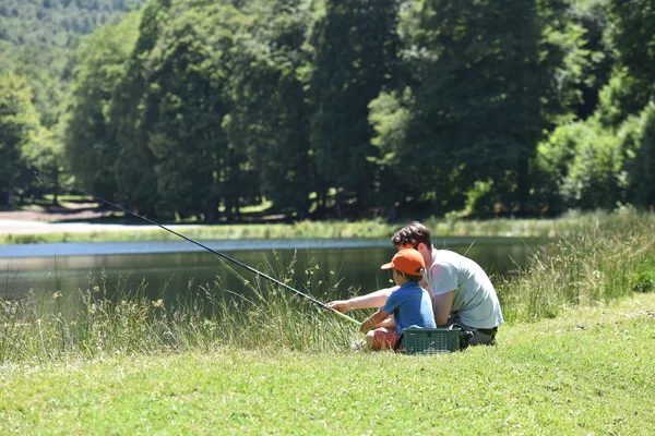 Dad with little boy fishing