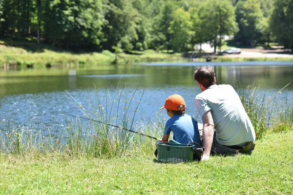 Dad with little boy fishing