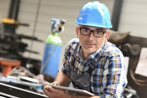 Engineer using tablet in workshop