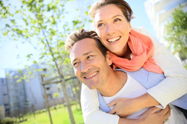 Man giving piggyback ride to woman