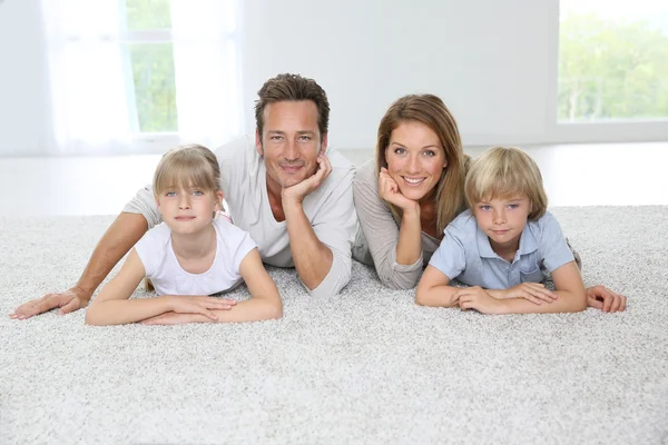 Family laying on carpet at home