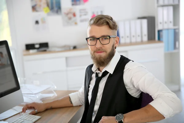 Man with beard and eyeglasses in office
