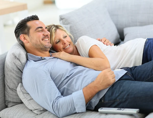 Couple in sofa watching tv