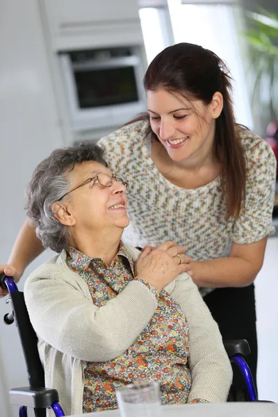 Woman in wheelchair with home carer