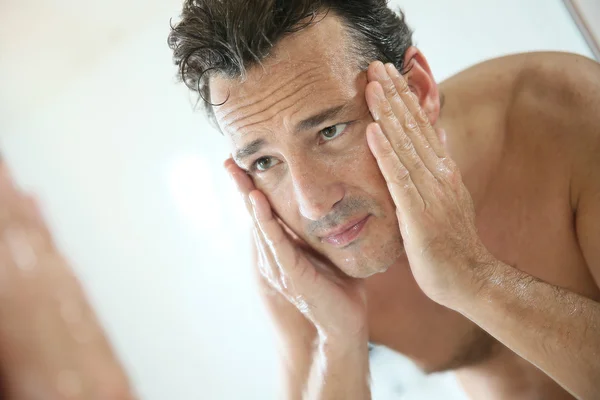 Man rinsing face after shaving