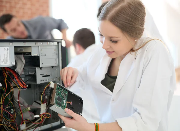 Student girl fixing computer