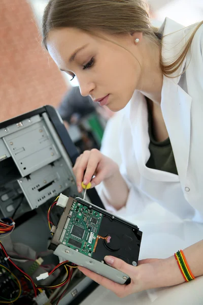 Student girl fixing computer