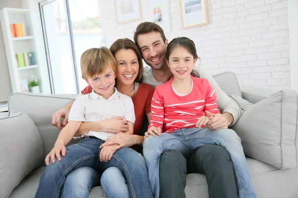 Family sitting on sofa