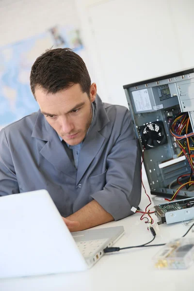 Technician fixing computer hardware