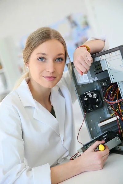 Girl fixing computer hard drive