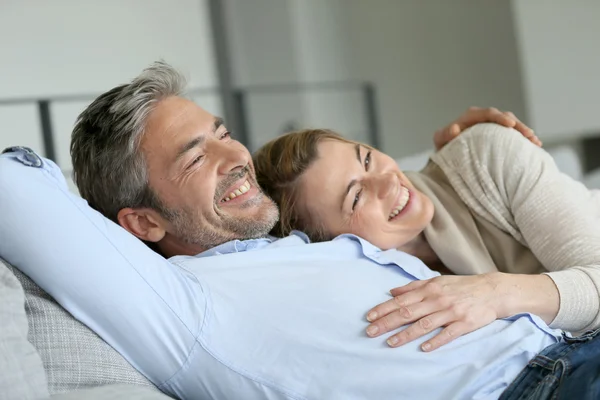 Mature couple relaxing on sofa