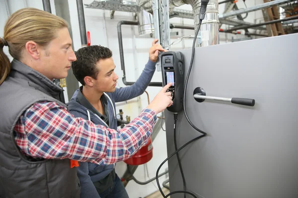 Man measuring heat pump temperature