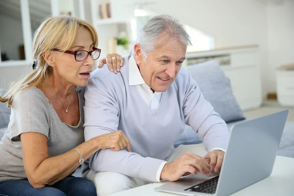 Couple at home websurfing