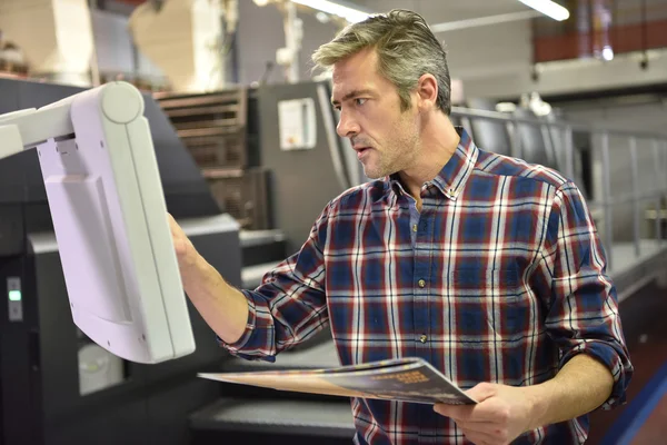 Man working on printing machine