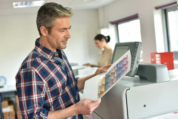 Man programming printer machine