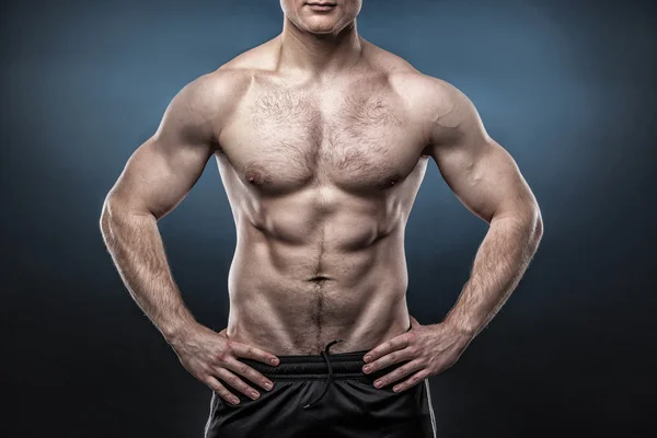 Torso of young man isolated on dark blue background