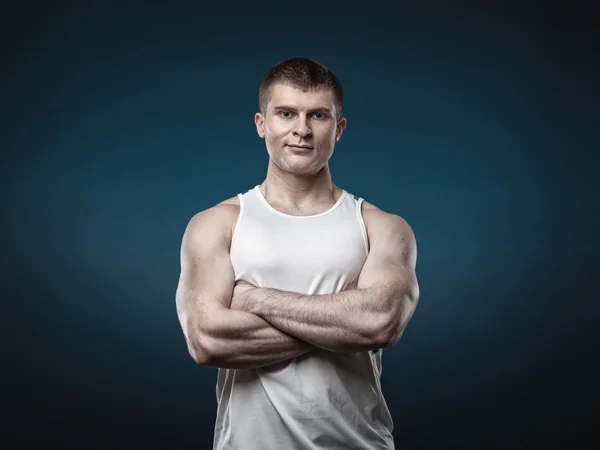 Young muscular man isolated on gray background