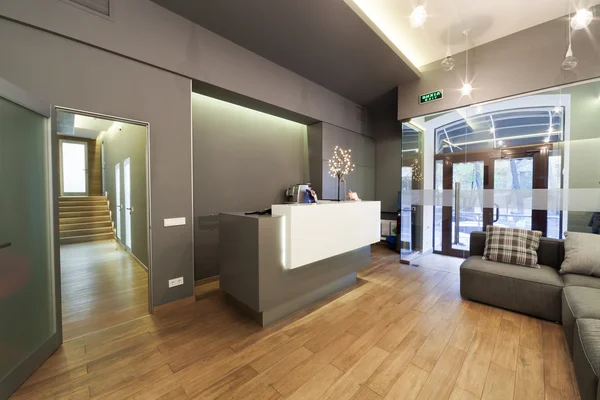 Lobby entrance with reception desk in a dental clinic.