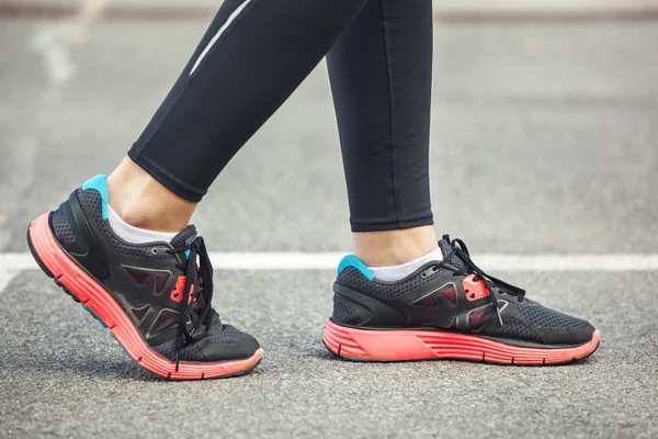 Close up of running shoes on road.