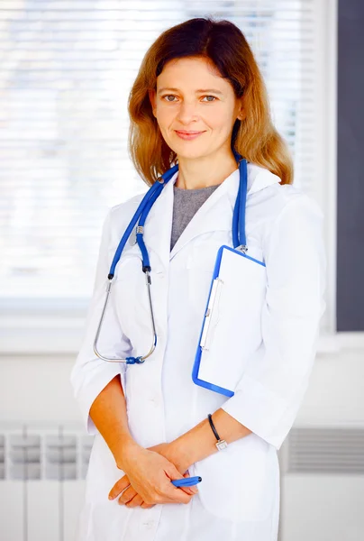 Portrait of family doctor looking at camera and smiling.