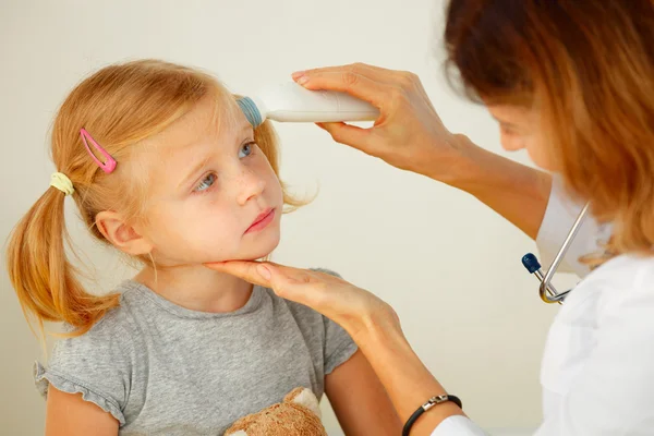 Pediatrician taking temperature with thermometer.