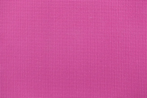 Pink yoga mat closeup.
