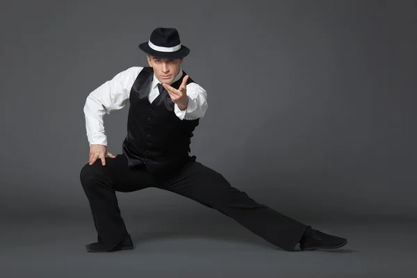 Young male professional dancer dancing in studio.