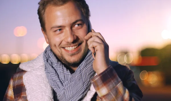 Handsome young man speaking on smartphone