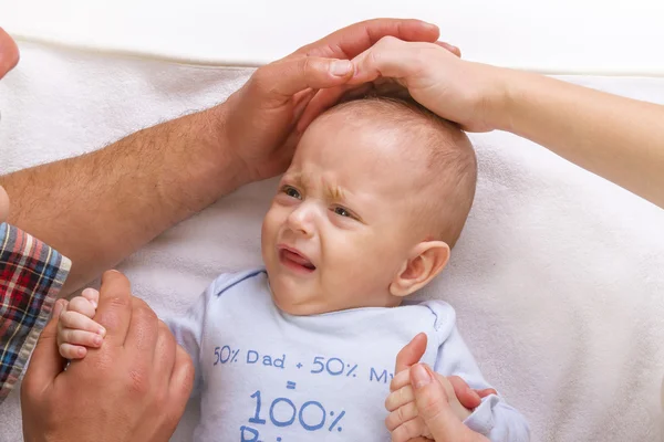 Parents calm a crying baby