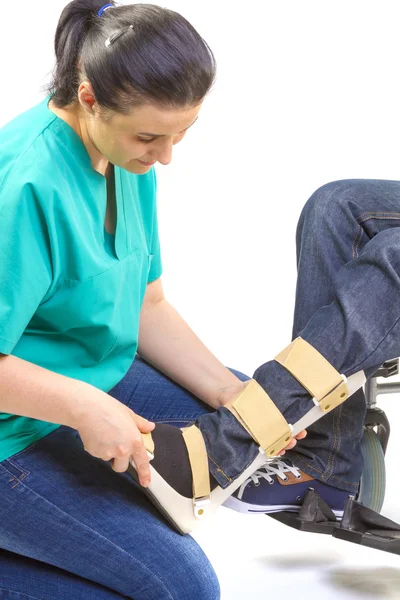 Orthopedic equipment for young man in wheelchair