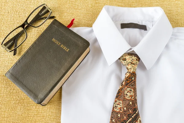 Business man style clothes and Holy Bible at home