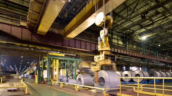 Loading of metal on a roll in the plant, steel coils