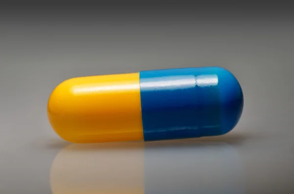 Yelow and blue pill, antibiotic - medical background