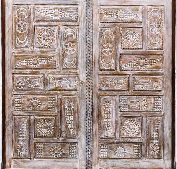 Islamic geometric stars motif pattern, carved on the surface of an old wooden door.