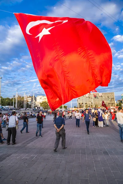 Turkish people gathering and waving flags at Taksim Square. The meetings were called Duty for Democracy after the failed July-15 coup attempt of Gulenist militants.