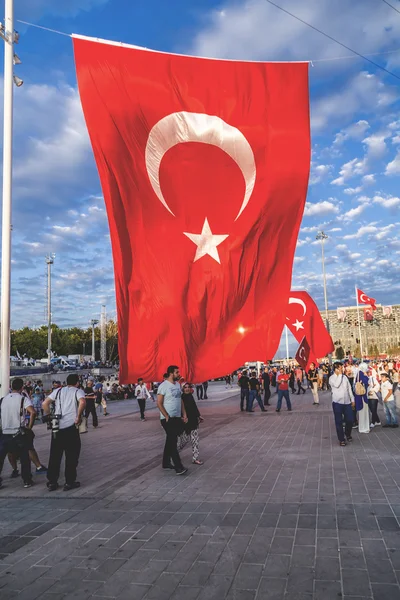 Turkish people gathering and waving flags at Taksim Square. The meetings were called Duty for Democracy after the failed July-15 coup attempt of Gulenist militants.